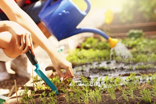 Gardener working on a front garden in Gipsy Hill with tools